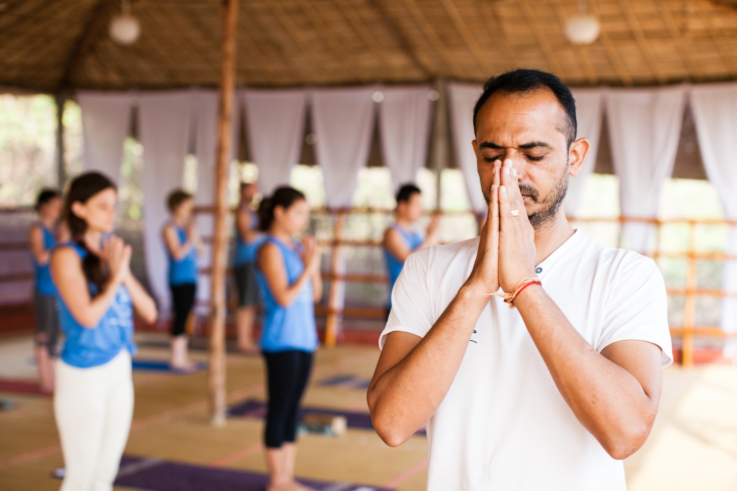 Yoga Teacher with hands in prayer