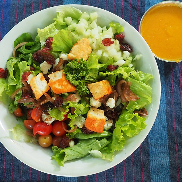 Salad and yellow sauce in bowl
